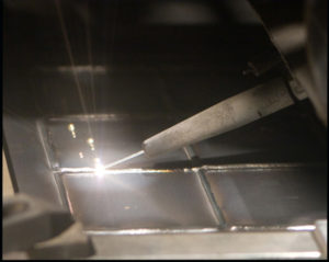 A beam laying down a molten wire for additive layer manufacturing